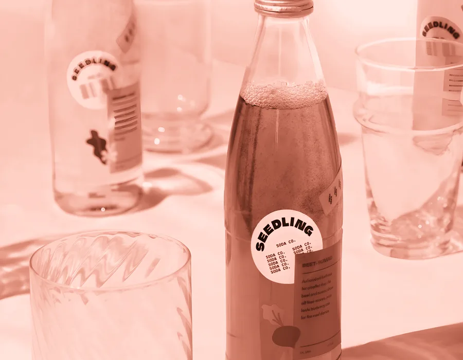 Bottled soft drinks styled on a table, the product at the centre of the Fizzbomb Drinks campaign