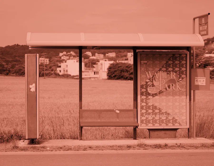 A roadside transit shelter carrying a panel ad, the format the Harlow Transit campaign ran on