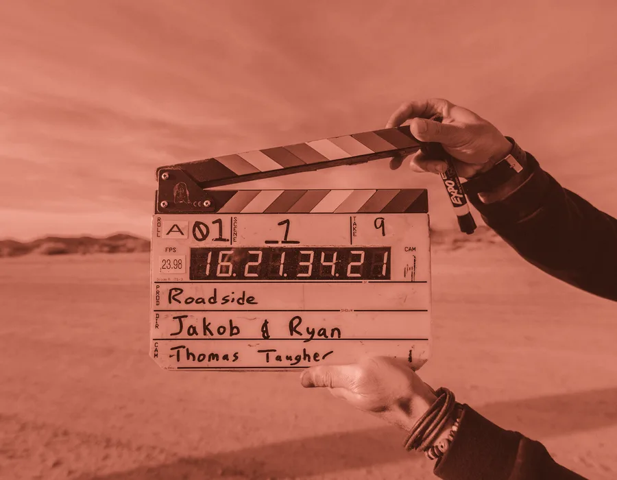 A clapperboard held up on location, marking a take for the Nimbus Bank film shoot