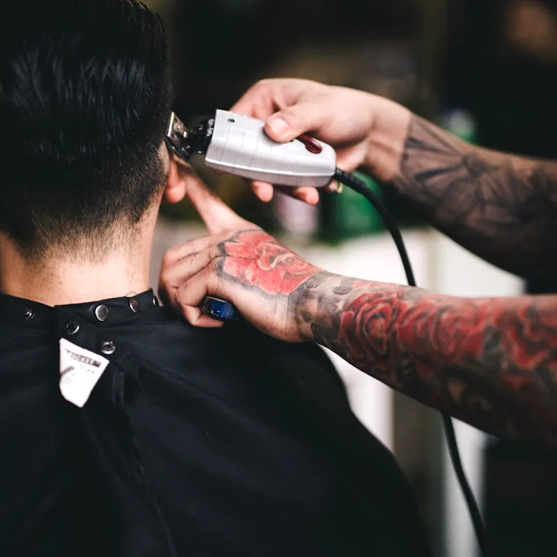 Clippers being run through a client's hair, close up