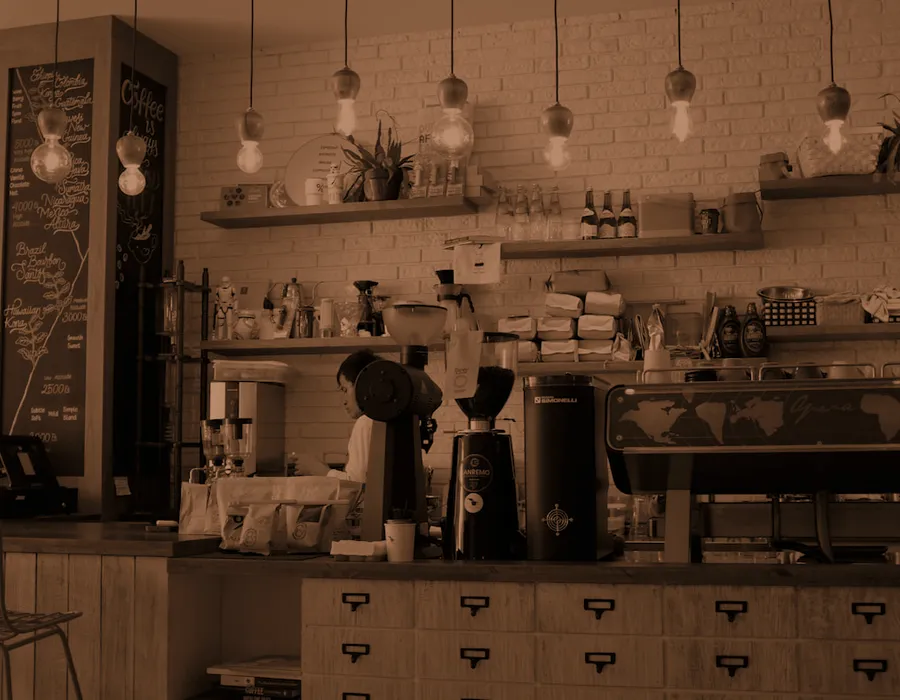 The roastery counter with shelves of coffee behind it