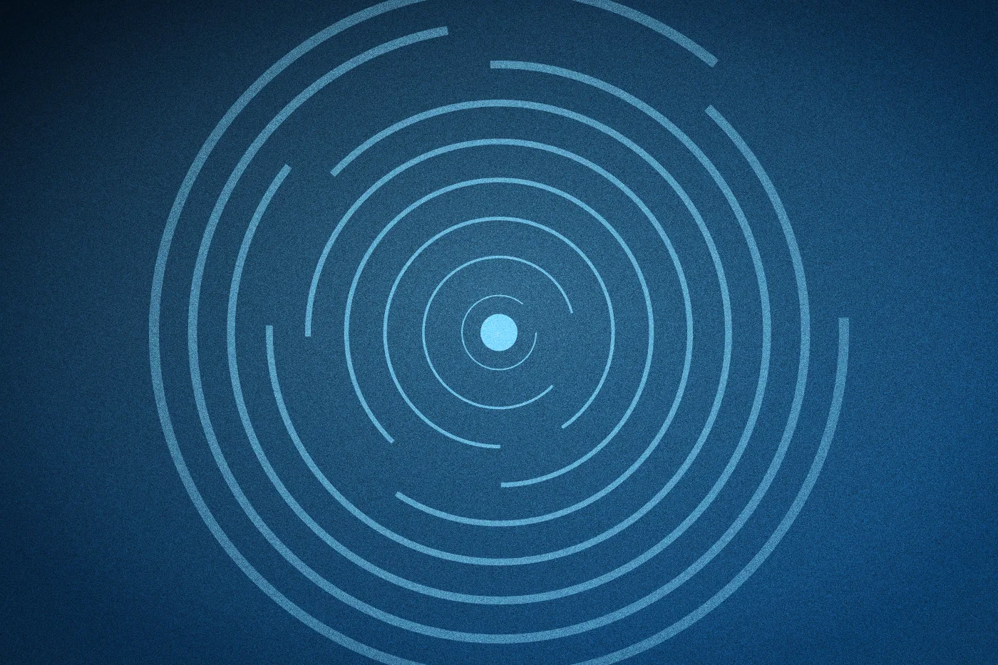 Broken pale blue rings spiralling out from a solid core on deep blue.
