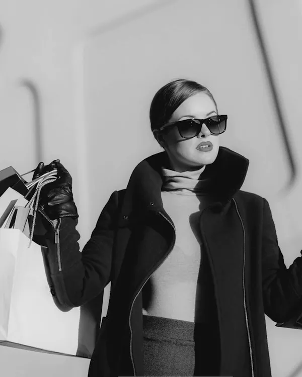 Model in a long wool coat with sunglasses