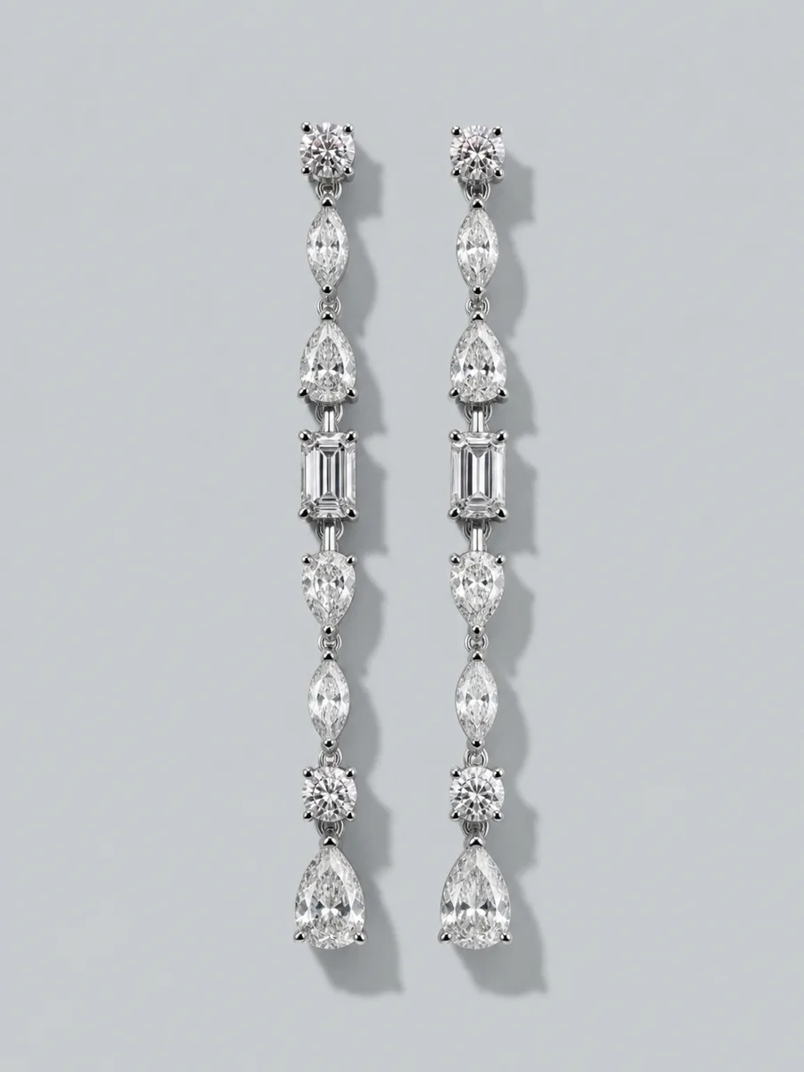 A pair of long platinum drop earrings set with marquise and pear cut stones.