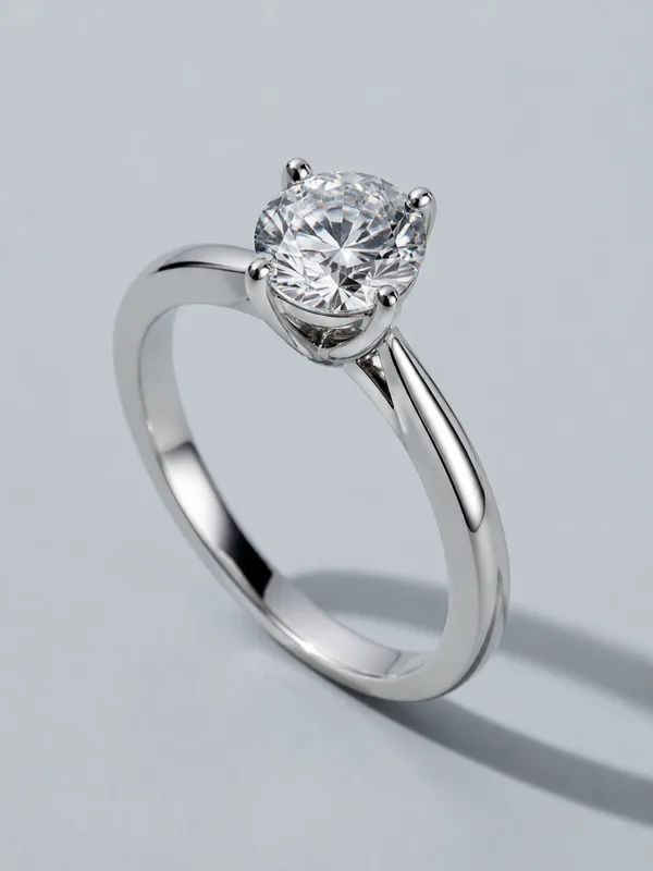 A platinum engagement ring with a round brilliant stone held in fine claws.