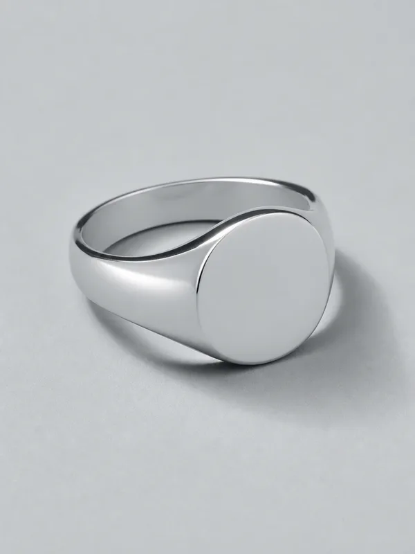 A platinum signet ring with a plain oval face.