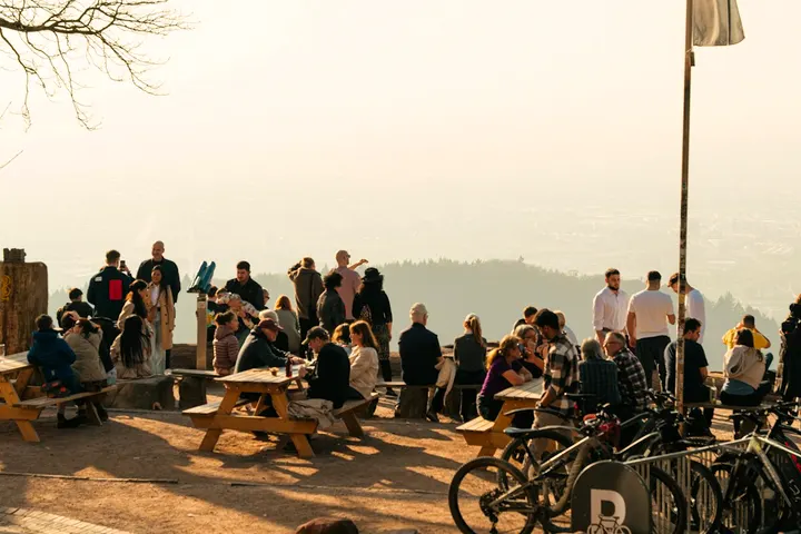 Picnic benches and a hazy view from the top of the Downs