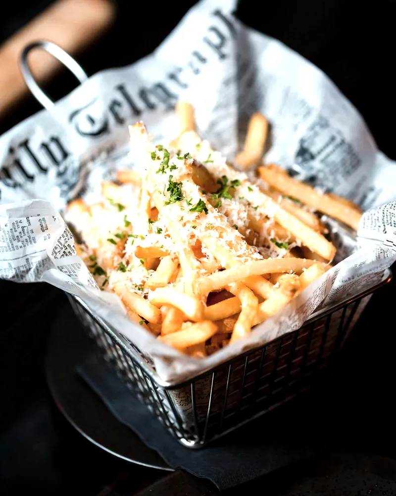 A basket of dirty fries in paper