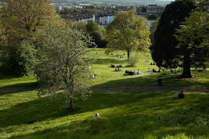 People sitting out on the grass at College Green