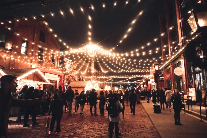 String lights over the evening crowd at Wapping Wharf