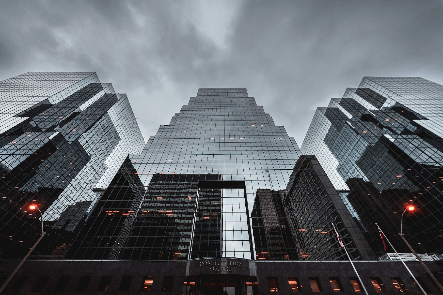 Glass towers of Constitution Square rising into a stormy sky in Ottawa