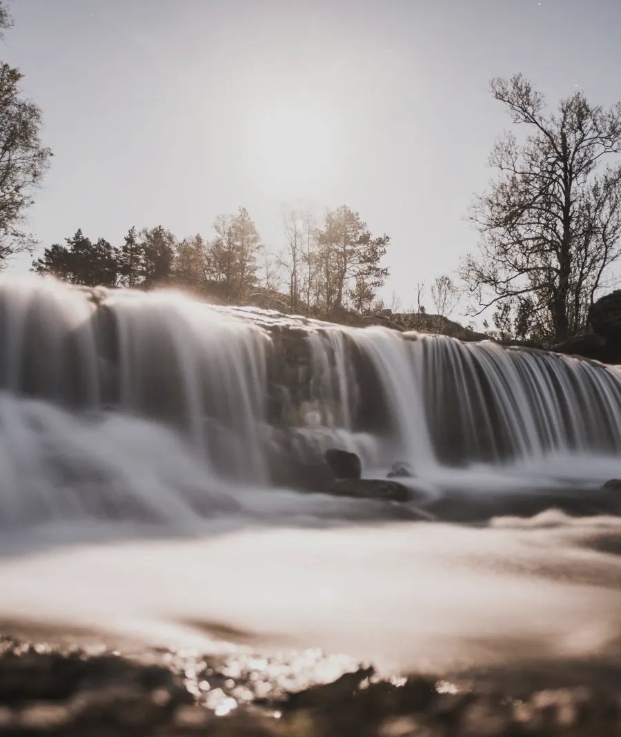 A wide waterfall in low sun