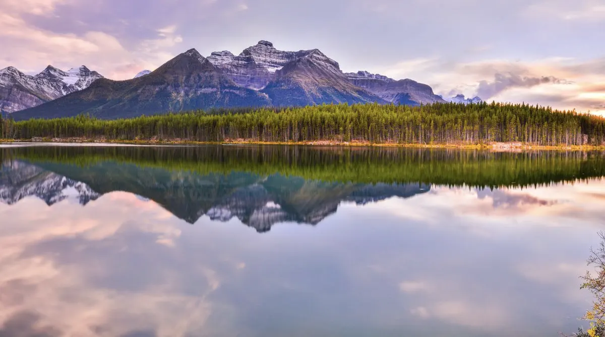 Mountains reflected in a still lake at dusk