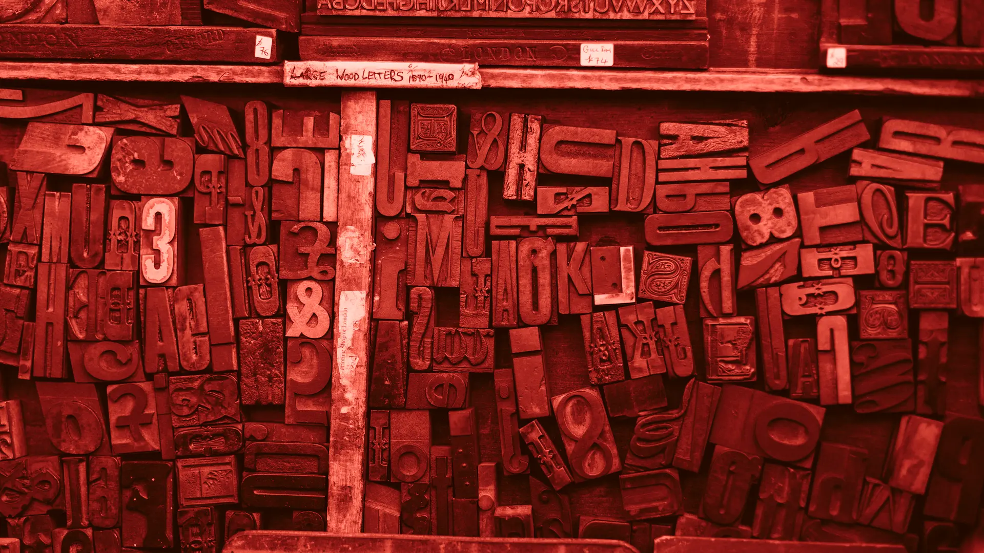 Screen-printed posters drying on a rack in the Measure press room