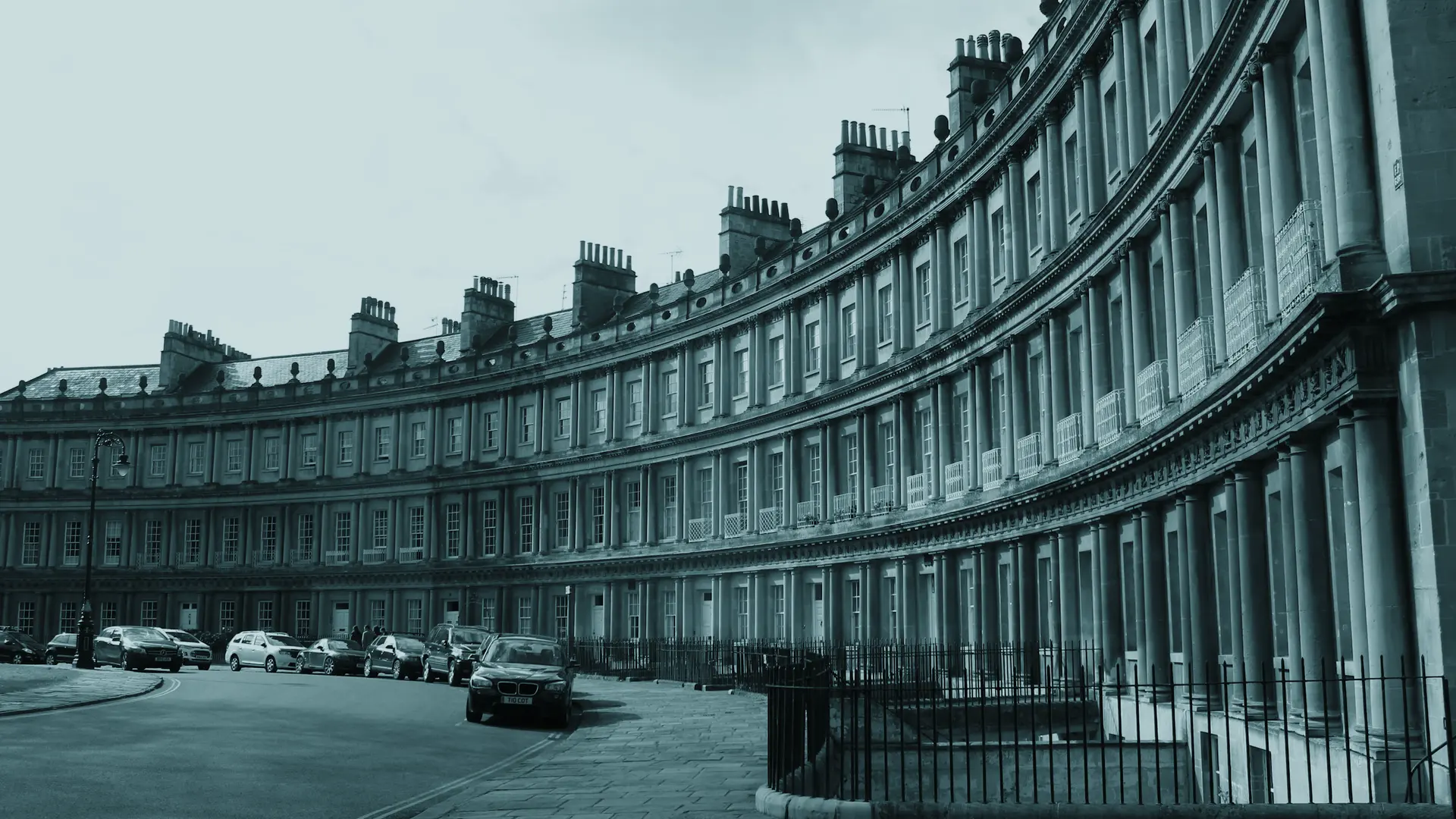 A Georgian crescent in Bath curving away in flat afternoon light