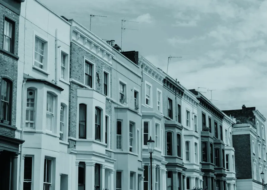 A parade of painted townhouses stepping up a hill