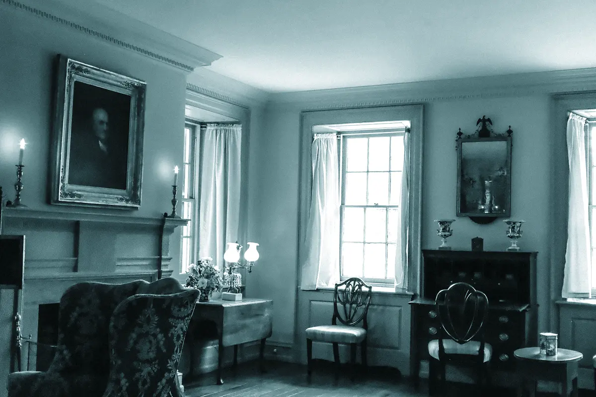 The first floor drawing room with three sash windows and a marble chimneypiece