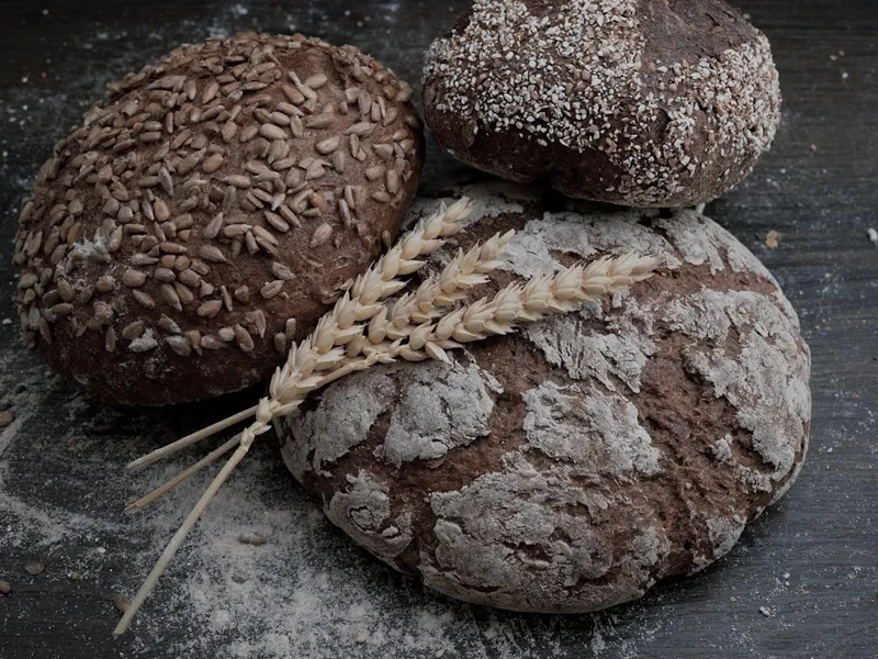 Dark rye sourdough loaves dusted with flour