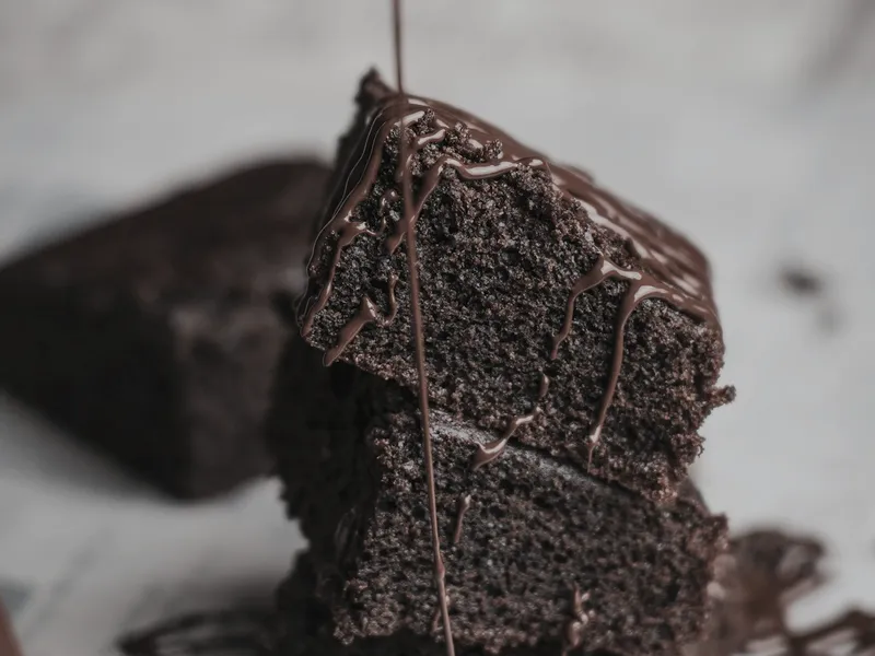 Slices of dark chocolate cake with glossy ganache