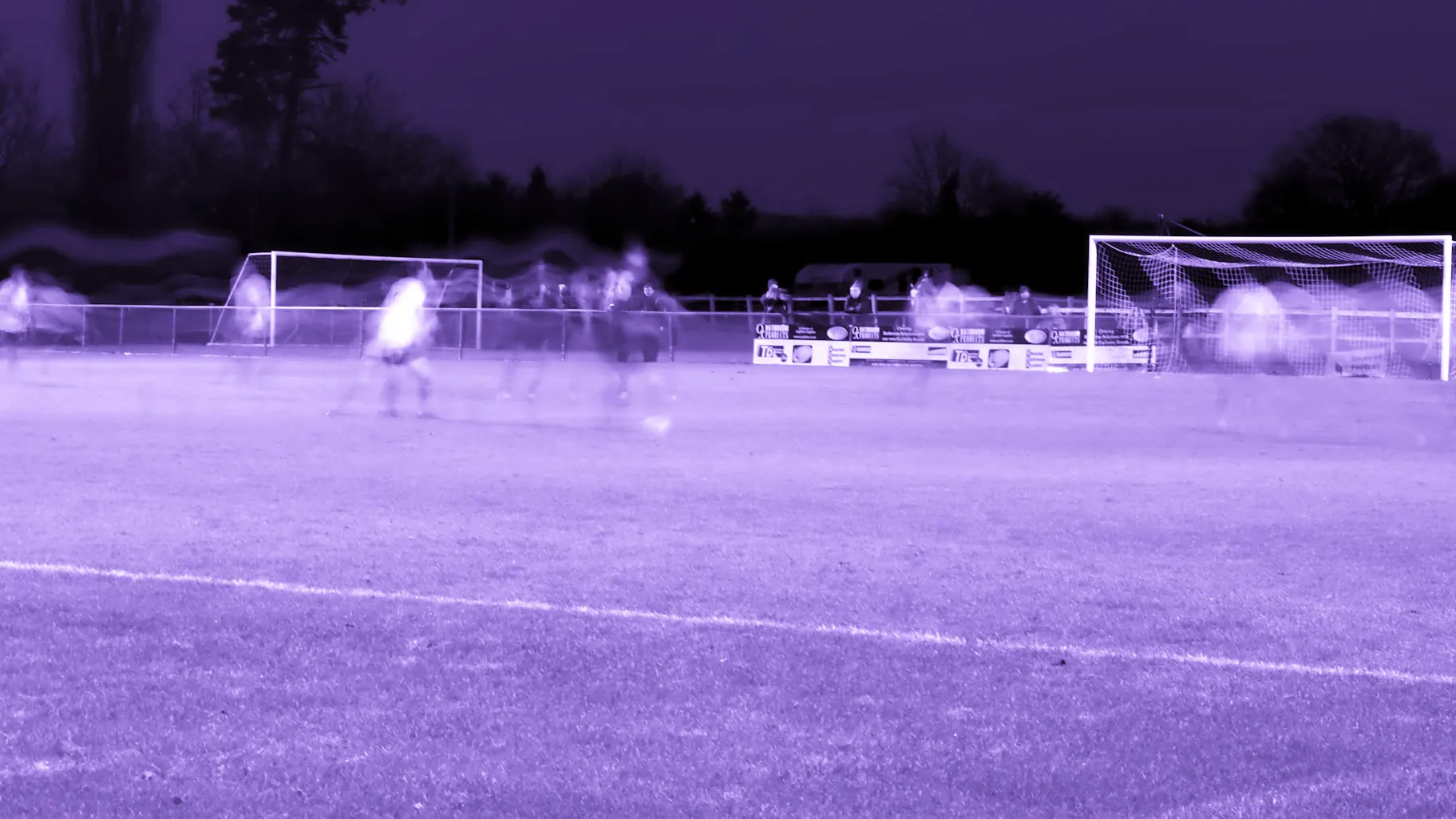 The Kiln under floodlights on a midweek evening, seen from the North terrace