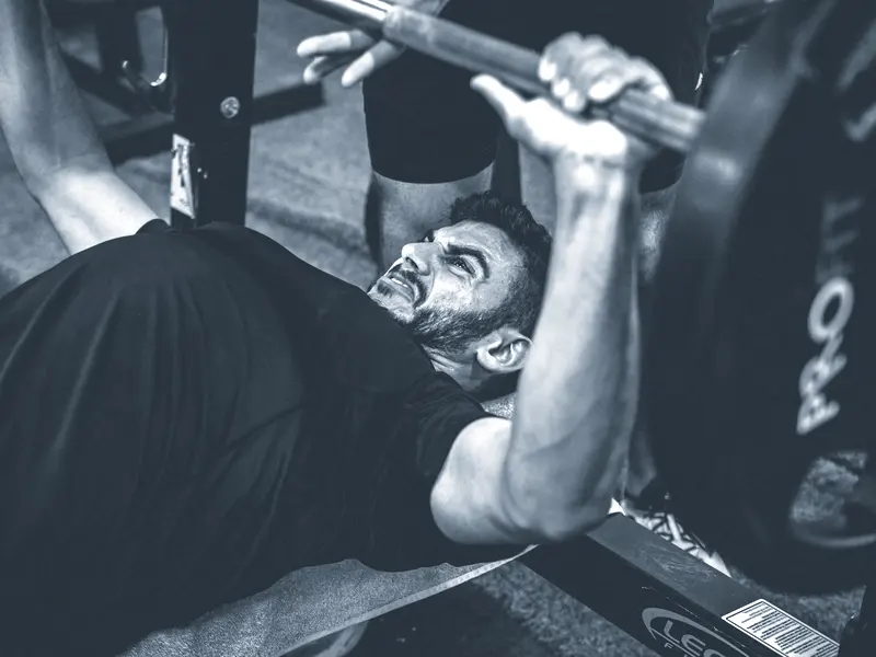 A lifter pressing on one of the competition benches