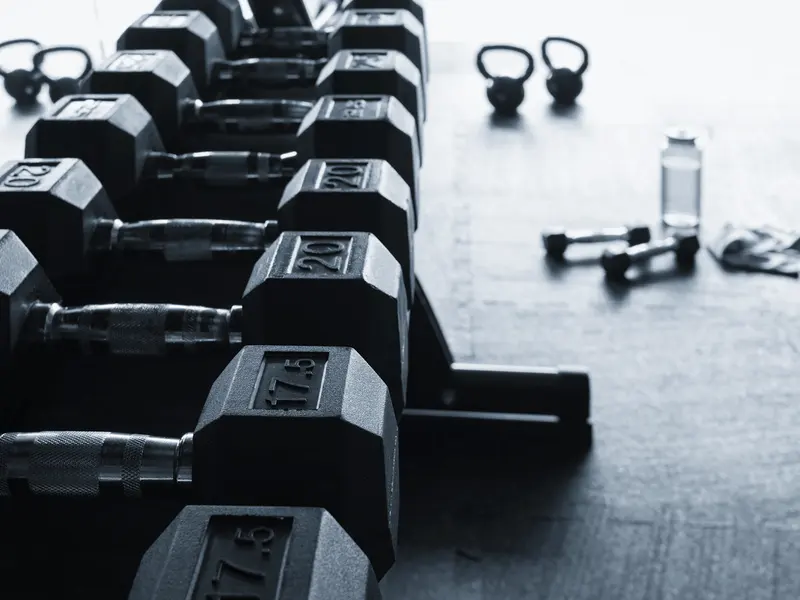 Dumbbells racked along the edge of the lifting floor