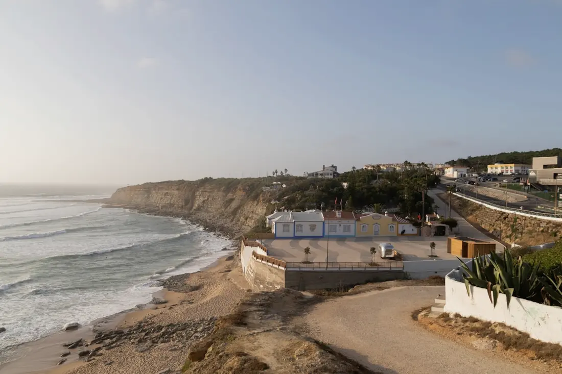 The cliffs and whitewashed houses above Porto Covo's harbour beach